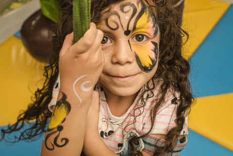 In Campo Grande, Brazil, a young girl sat for a portrait with her face painted like a butterfly, capturing a special and colorful memory for her family.